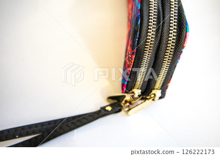 Closed women's textile purse on white background. Selective focus Closed women's textile purse on white background. Selective focus 126222173