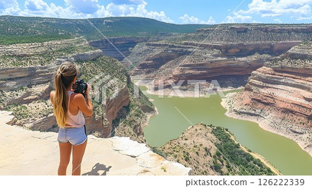 Woman Photographs Scenic Canyon River Bend on Sunny Day Woman Photographs Scenic Canyon River Bend on Sunny Day 126222339