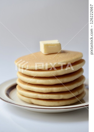 A simple layered pancake served with butter A simple layered pancake served with butter 126222667
