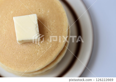 A simple layered pancake served with butter 126222669