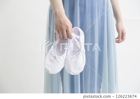 Woman with ballet shoes 126223674
