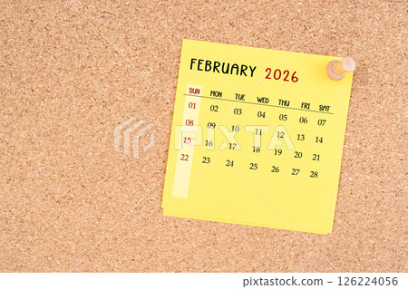 Yellow calendar sheet for February 2026 with thumbtack on board. Yellow calendar sheet for February 2026 with thumbtack on board. 126224056