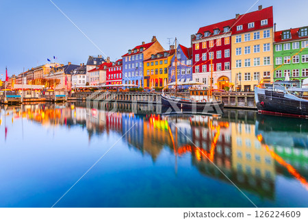 Copenhagen, Denmark. Nyhavn, Kobenhavn's iconic canal, colorful night water reflection. 126224609