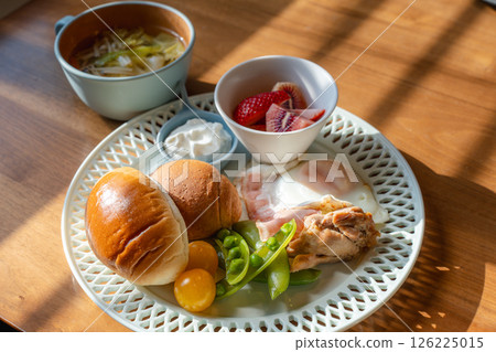 A Western-style breakfast plate with the morning sun shining through 126225015