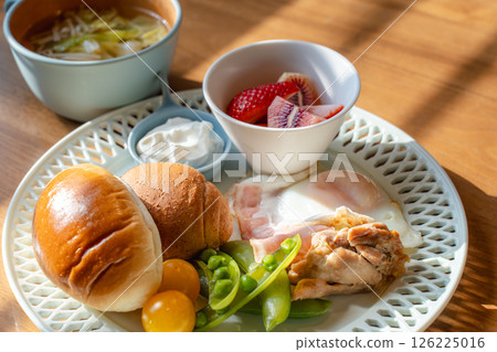 A Western-style breakfast plate with the morning sun shining through 126225016