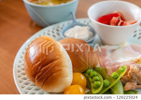 A Western-style breakfast plate with the morning sun shining through 126225024