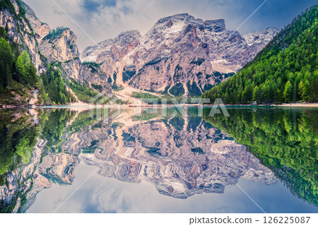 Lago di Braies, Italy. Alpine lake with emerald waters, dramatic Dolomites peaks, wooden boats, and breathtaking scenic beauty. Lago di Braies, Italy. Alpine lake with emerald waters, dramatic Dolomites peaks, wooden boats, and breathtaking scenic beauty. 126225087