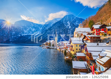 Hallstatt, Austria. Idyllic Alpine village snow-covered, serene lake, majestic mountains  and sunny winter charm. 126225098