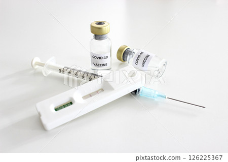 Vial of Covid-19 vaccine, 1 ml plastic syringe with needle and Positive test result of Covid-19 antigen test kit isolated on the white background Vial of Covid-19 vaccine, 1 ml plastic syringe with needle and Positive test result of Covid-19 antigen test kit isolated on the white background 126225367