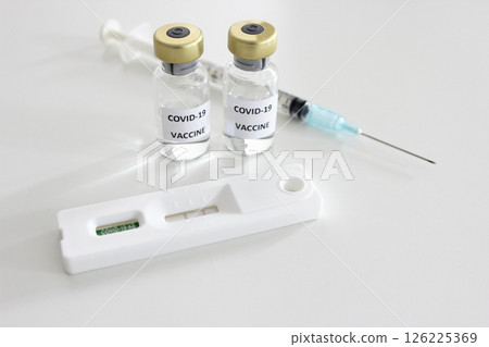 Vial of Covid-19 vaccine, 1 ml plastic syringe with needle and Positive test result of Covid-19 antigen test kit isolated on the white background Vial of Covid-19 vaccine, 1 ml plastic syringe with needle and Positive test result of Covid-19 antigen test kit isolated on the white background 126225369