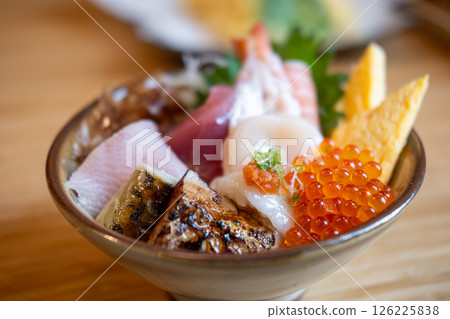 Kaisen Don, a Japanese rice bowl dish of seafood. Including raw fish such as Hotate, Salmon, Saba, Engawa, Foie gras, Ikura. Kaisen Don, a Japanese rice bowl dish of seafood. Including raw fish such as Hotate, Salmon, Saba, Engawa, Foie gras, Ikura. 126225838