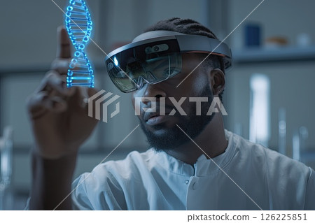 Male scientist wearing an AR headset interacting with a holographic DNA structure. Wearing an AR headset, the scientist engages with a vibrant holographic DNA model for research. 126225851