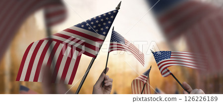 A group of people holding USA flags in their hands 126226189