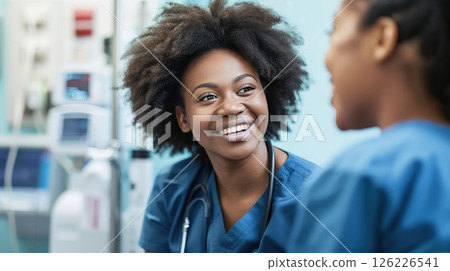 Hospital staff having fun chatting with each other during a break. Moments of joy and laughter punctuate the hospital routine, reminding staff of the importance of self-care. Hospital staff having fun chatting with each other during a break. Moments of joy and laughter punctuate the hospital routine, reminding staff of the importance of self-care. 126226541