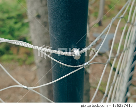 End tensioning joints on a modern wire fence. Anchor eye with thread and tensioning mechanism End tensioning joints on a modern wire fence. Anchor eye with thread and tensioning mechanism 126227413