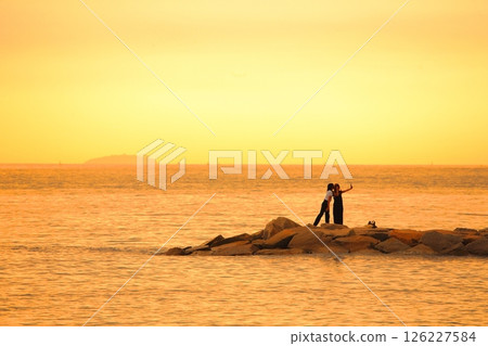 A woman playing in the sea in the evening 126227584