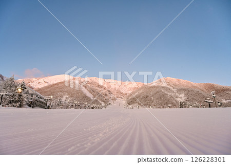 A beautiful ski resort illuminated by the morning sun A beautiful ski resort illuminated by the morning sun 126228301