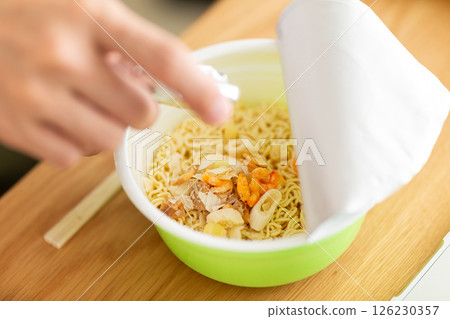Hands of a middle-aged man making cup ramen 126230357