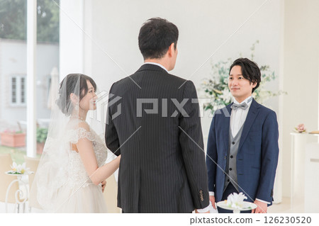 A groom/groom man waiting for a bride to walk on a virgin road at a wedding hall/chapel 126230520