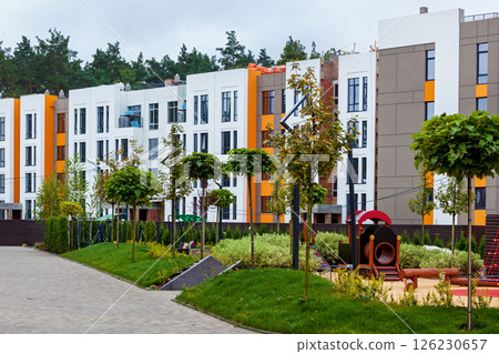 Modern residential complex with landscaped courtyard and playground 126230657