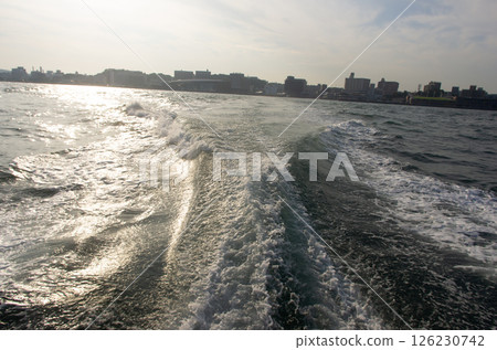 The wake of a ferry crossing the Kanmon Straits and the city of Shimonoseki 126230742