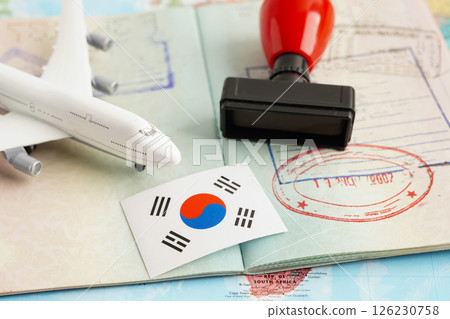 South Korea flag and passport with airplane for travel. South Korea flag and passport with airplane for travel. 126230758