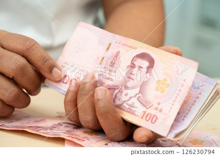 Asian woman counting Thai baht banknote money and holding in hand, investment economy, accounting business and banking. 126230794