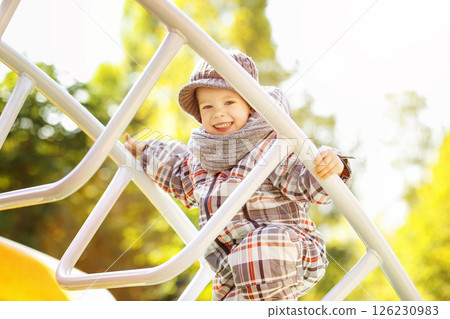 Happy child portrait at sunny autumn park playground. 126230983