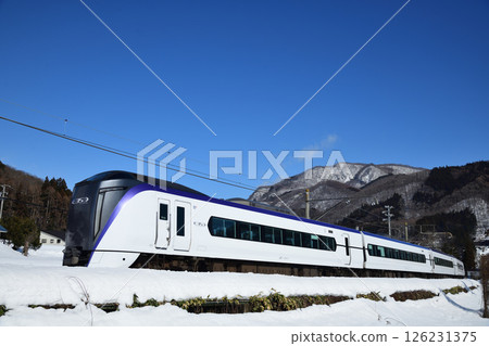 Oito Line express train running through snowy fields Oito Line express train running through snowy fields 126231375