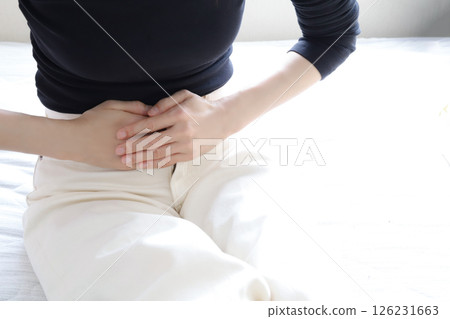 A woman who holds her stomach A woman who holds her stomach 126231663