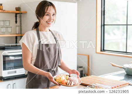 A housewife serving a one-plate lunch in the kitchen 126231905