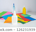 Colored paper and glue on the table 126231939