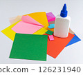 Colored paper and glue on the table 126231940