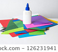 Colored paper and glue on the table 126231941