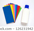 Colored paper and glue on the table 126231942