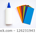 Colored paper and glue on the table 126231943