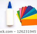 Colored paper and glue on the table 126231945