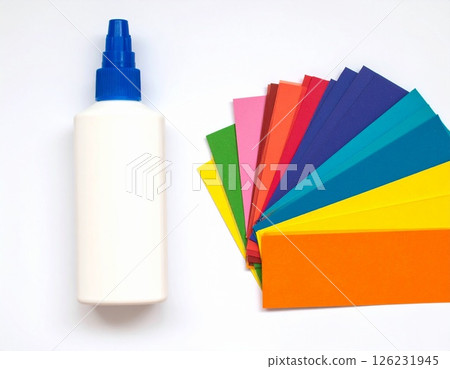 Colored paper and glue on the table 126231945