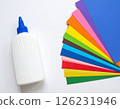 Colored paper and glue on the table 126231946