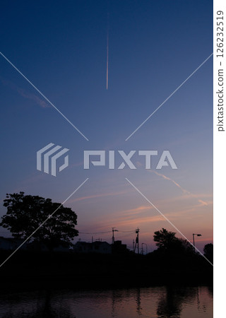 Evening landscape with contrails 126232519