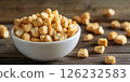 Bowl of crispy cereal cubes on rustic table 126232583