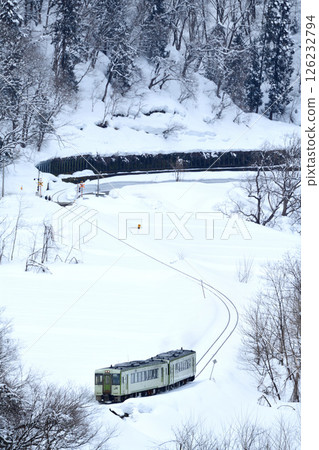 Iiyama Line Kiha 110 local train running through the snowy fields along the Chikuma River Iiyama Line Kiha 110 local train running through the snowy fields along the Chikuma River 126232794