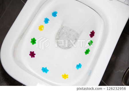 Multi-colored flowers in the toilet with different smells. Antibacterial and cleansing effect, close-up Multi-colored flowers in the toilet with different smells. Antibacterial and cleansing effect, close-up 126232956