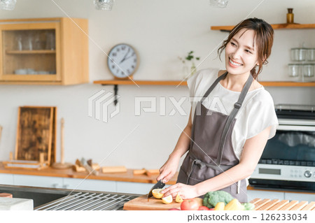 Young Asian woman cooking in the kitchen (cutting, knife, cooking, home cooking) 126233034
