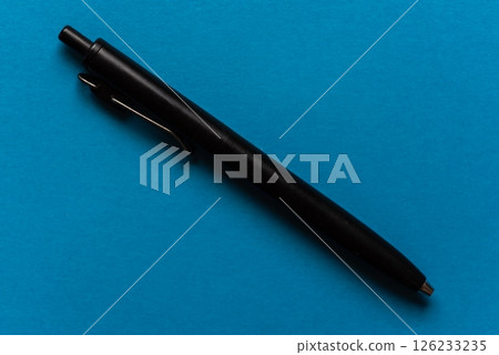 Ballpoint pen on a blue background 126233235