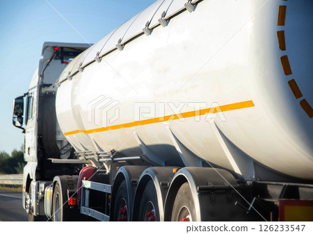 A truck tractor with a tank semi-trailer is transporting a hazardous flammable cargo - fuel. Transportation of diesel fuel in a tank. Cargo hazard class A truck tractor with a tank semi-trailer is transporting a hazardous flammable cargo - fuel. Transportation of diesel fuel in a tank. Cargo hazard class 126233547