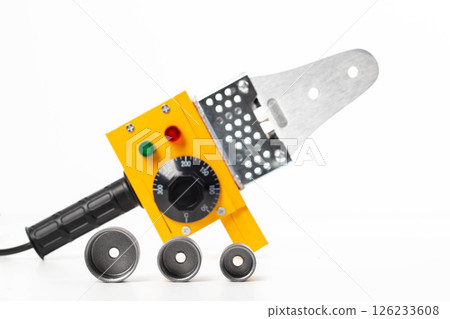 Plumbing electric soldering iron with different nozzles for welding polypropylene pipes on a white background, isolate, close-up 126233608