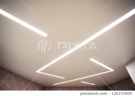 Modern stylish stretch ceiling with LED light lines. Designer geometric ceiling Modern stylish stretch ceiling with LED light lines. Designer geometric ceiling 126233609