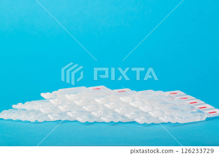 Tubes with probiotic and new generation metabiotic on a blue background. The concept of treating diseases of the gastrointestinal tract with succinic acid and bacteria. Copy space for text 126233729