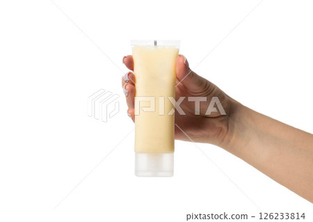 Brown tube with nourishing lifting face mask in hand on white background, isolate, close-up 126233814